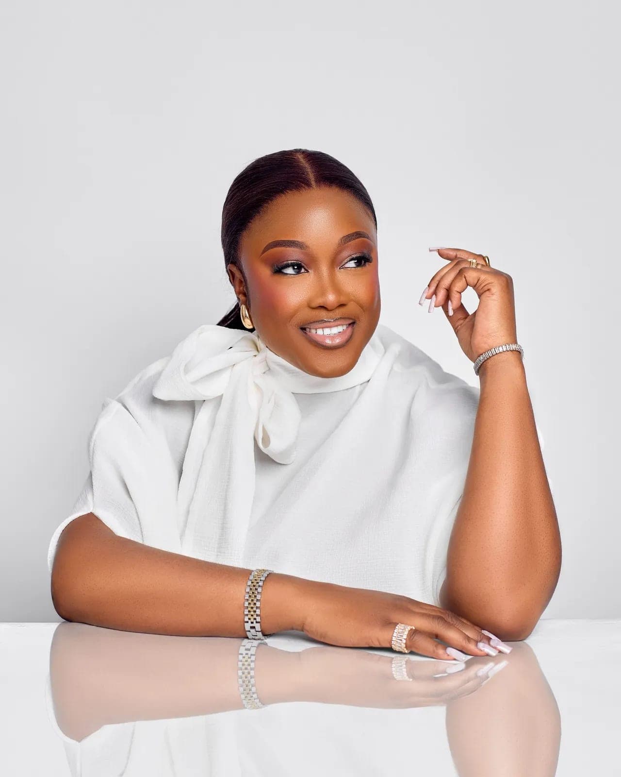 Studio portrait of Petra Odubayo in a white bow blouse